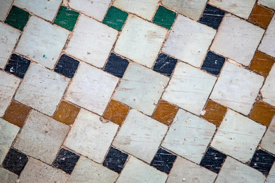 Zellige émaillé blanc, vert, bleu et ocre posé en diagonale
